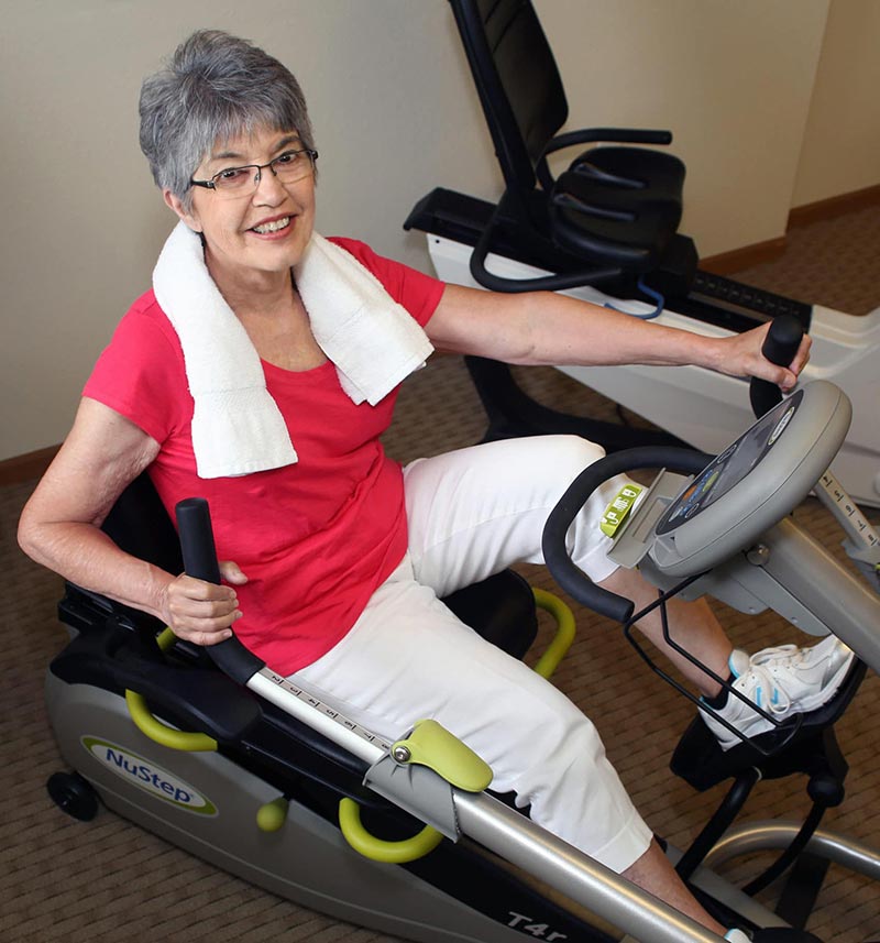 senior woman using exercise bike