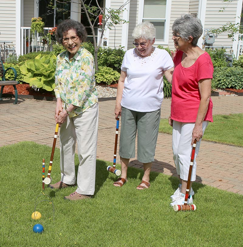 senior women playing croquet