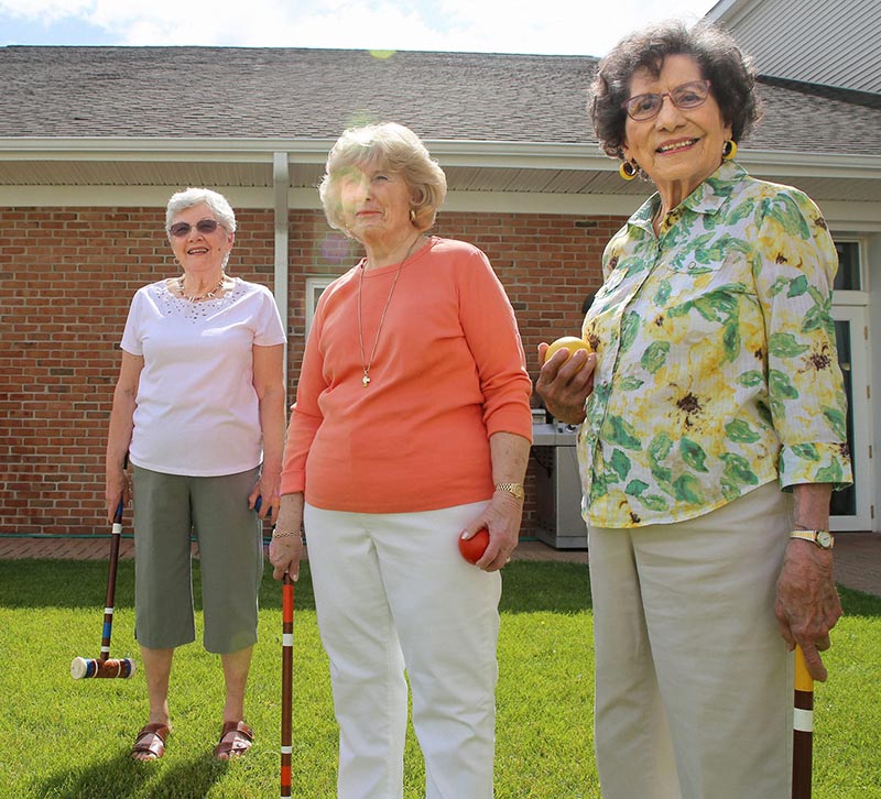 senior women playing croquet